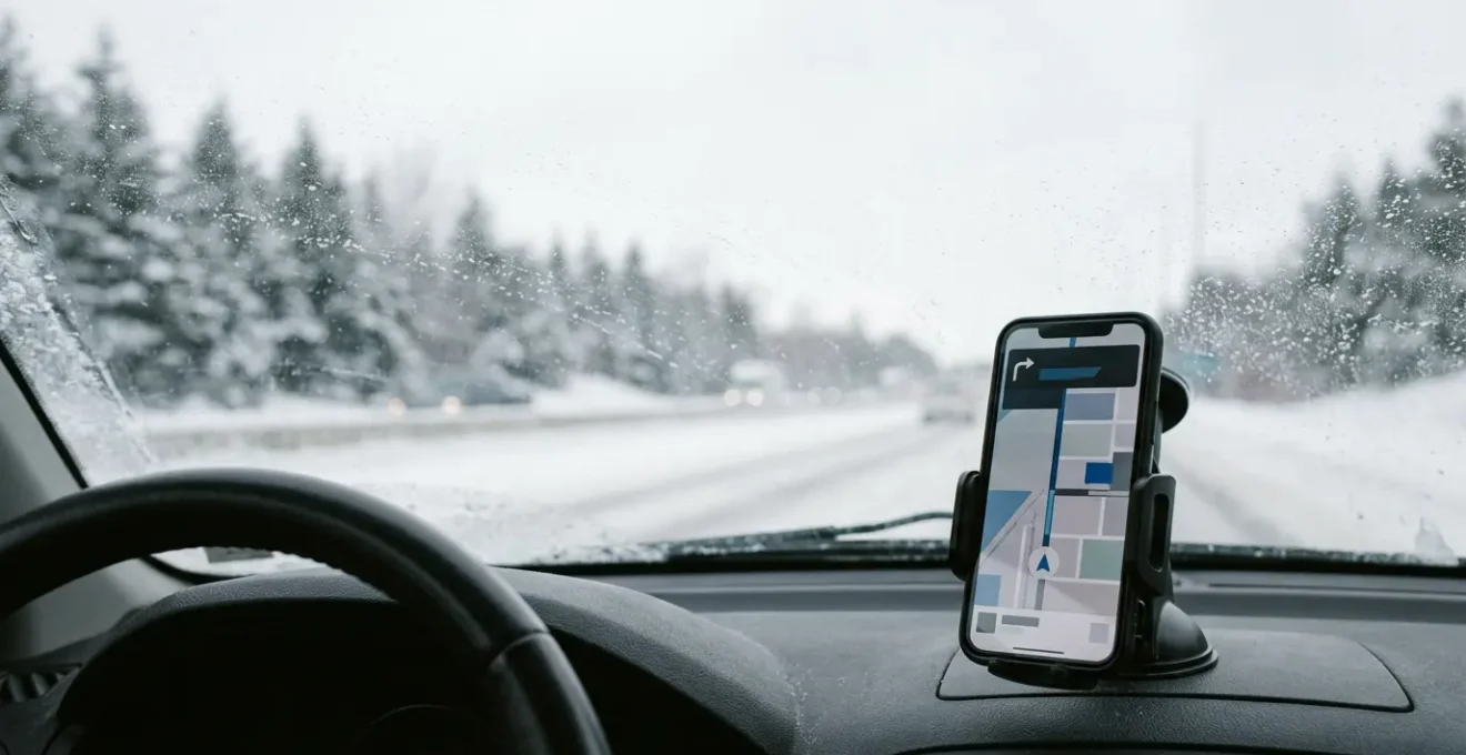 Canadian commuter's car dashboard during winter commute with smartphone navigation app interface visible